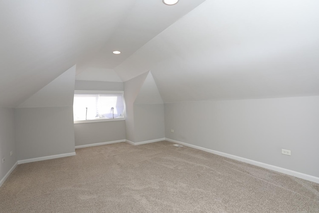 bonus room featuring light carpet and lofted ceiling