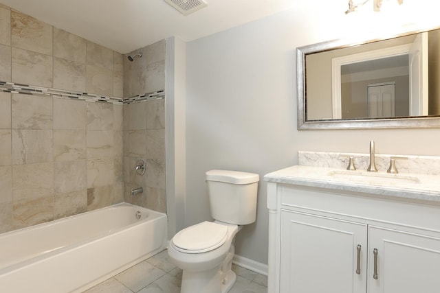 full bathroom featuring toilet, vanity, tiled shower / bath, and tile patterned flooring