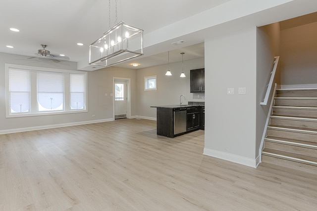 kitchen with stainless steel dishwasher, pendant lighting, ceiling fan, light wood-type flooring, and dark brown cabinetry