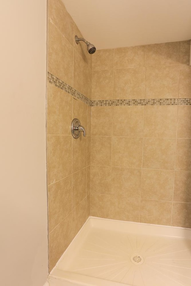 bathroom with tiled shower