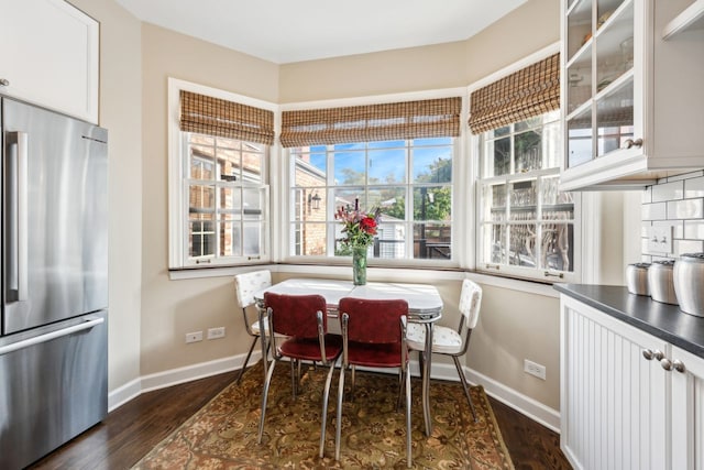 dining space with dark hardwood / wood-style flooring