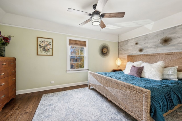 bedroom with dark hardwood / wood-style floors and ceiling fan