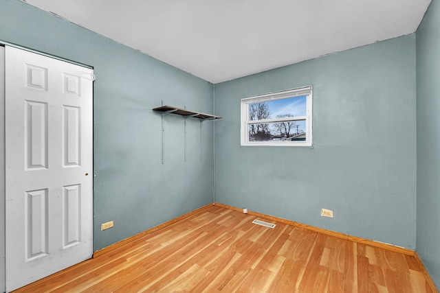 empty room with hardwood / wood-style floors