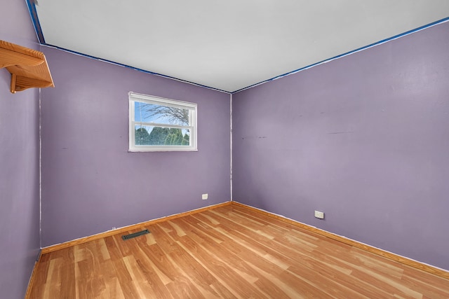 unfurnished room featuring hardwood / wood-style flooring