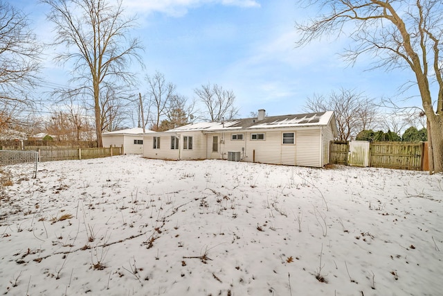 view of snow covered rear of property