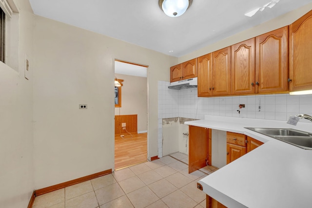 kitchen with sink, decorative backsplash, and light tile patterned floors