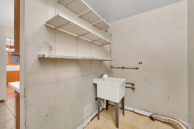 laundry room featuring an inviting chandelier