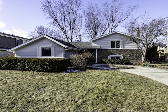 tri-level home with a garage and a front lawn