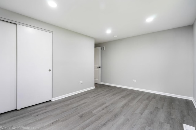 unfurnished bedroom featuring light hardwood / wood-style flooring and a closet