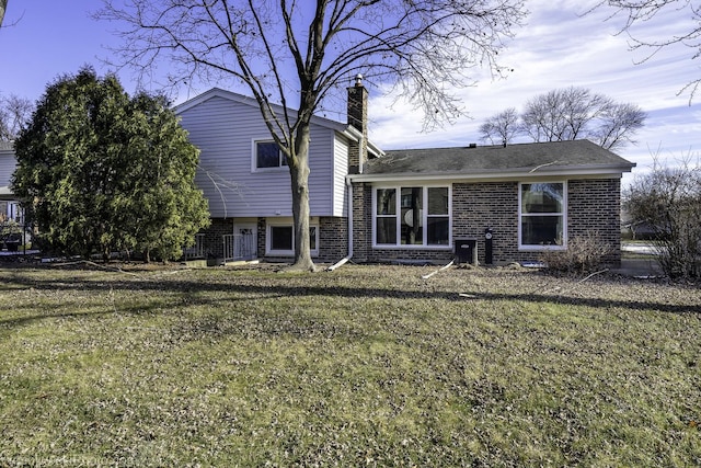 rear view of property with a lawn