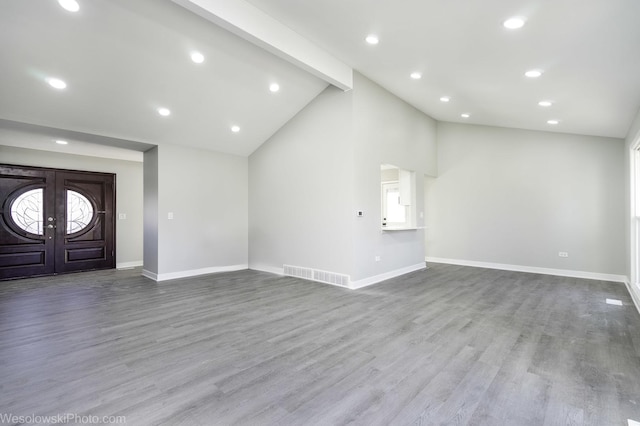 unfurnished living room featuring high vaulted ceiling, light wood-type flooring, beam ceiling, and french doors