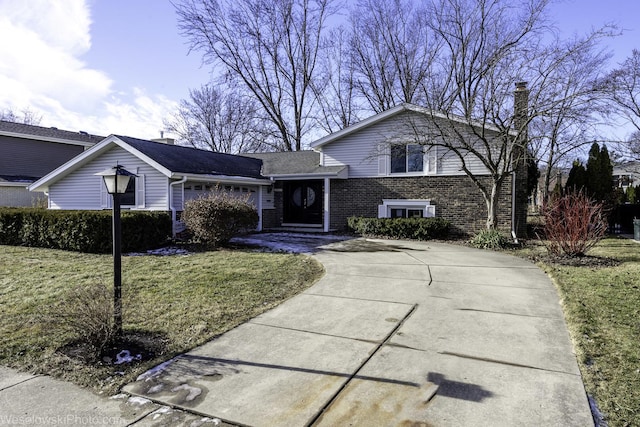 split level home with a garage and a front lawn