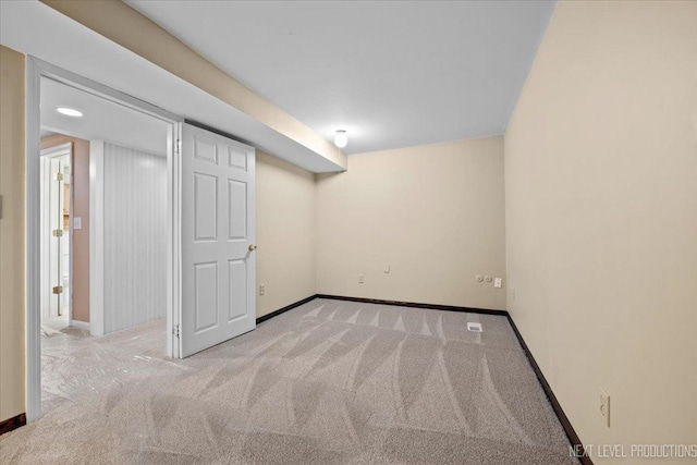 basement featuring light colored carpet