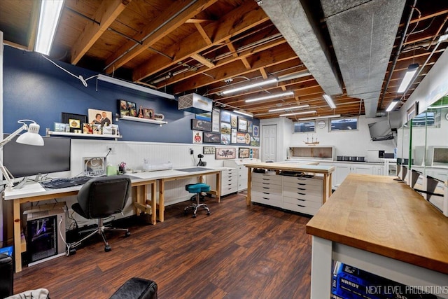 office space featuring dark hardwood / wood-style flooring and a workshop area