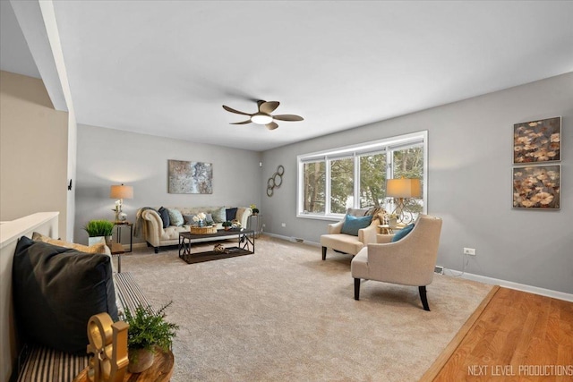 living room with light wood-type flooring and ceiling fan