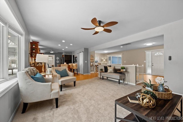 living room with light colored carpet and ceiling fan