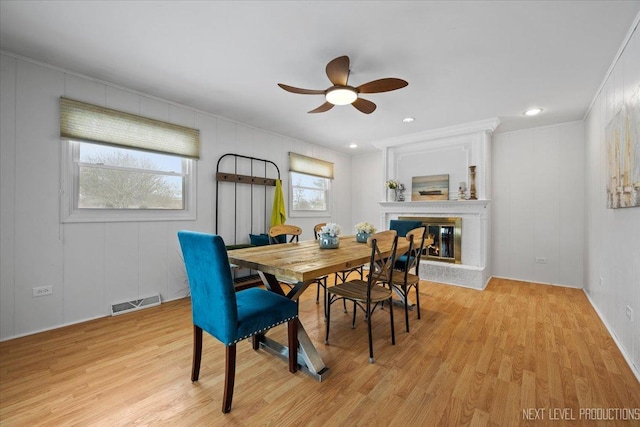 dining area featuring light hardwood / wood-style flooring, ceiling fan, and plenty of natural light