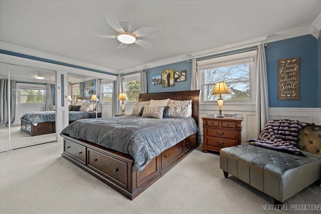 carpeted bedroom featuring ornamental molding and ceiling fan