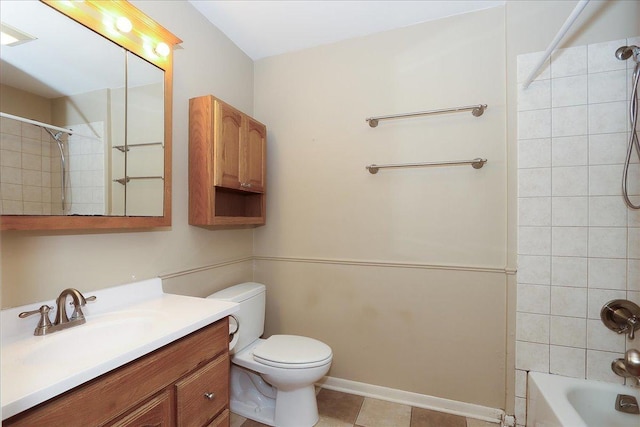 full bathroom featuring toilet, tiled shower / bath, and vanity