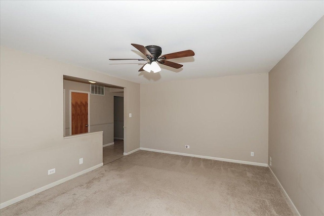 spare room with ceiling fan and light colored carpet