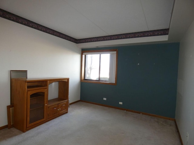 unfurnished living room featuring light carpet