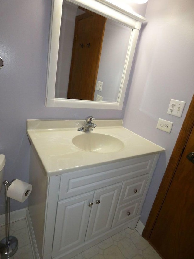 bathroom featuring vanity and toilet