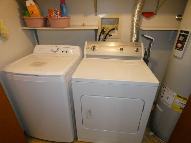 washroom with water heater and washer and dryer