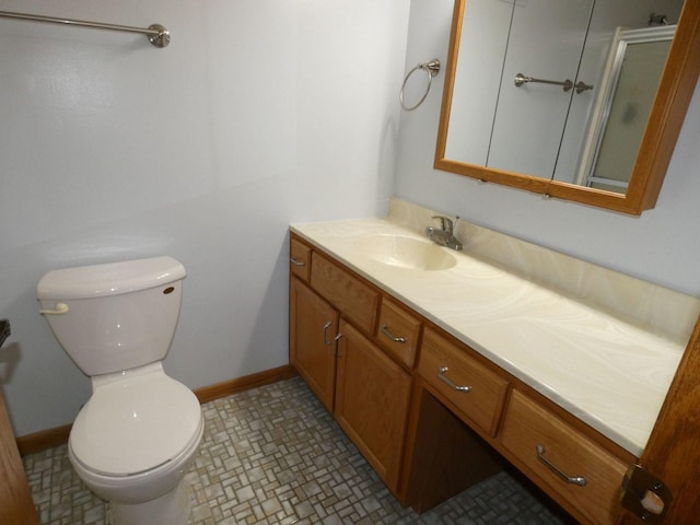 bathroom with vanity, toilet, and an enclosed shower