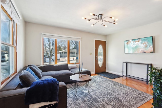 living room with hardwood / wood-style floors and a notable chandelier