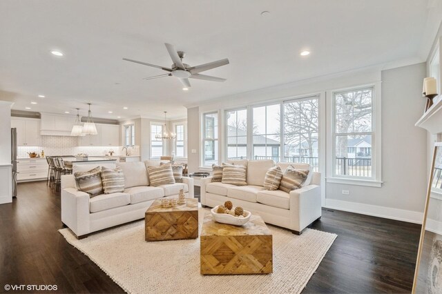 kitchen featuring pendant lighting, white cabinets, sink, backsplash, and ornamental molding