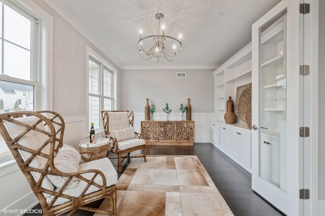 unfurnished living room featuring a wealth of natural light, crown molding, dark hardwood / wood-style flooring, and a tiled fireplace