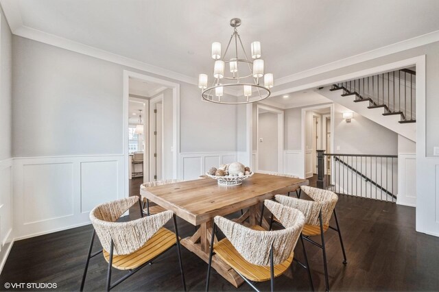 kitchen featuring dark hardwood / wood-style flooring, decorative light fixtures, appliances with stainless steel finishes, white cabinetry, and dark stone counters