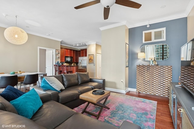 living room with dark hardwood / wood-style flooring, track lighting, ornamental molding, and ceiling fan