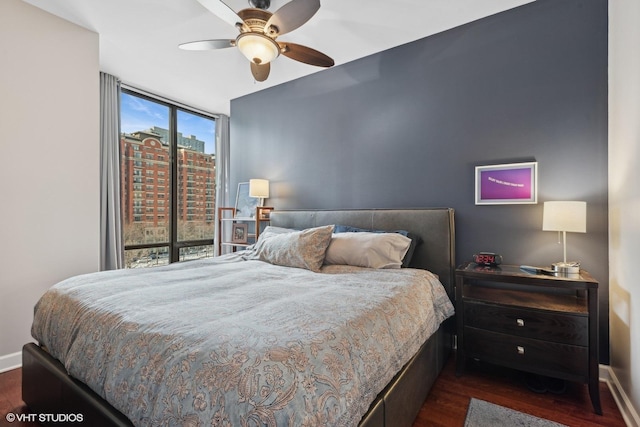 bedroom with dark wood-type flooring and ceiling fan