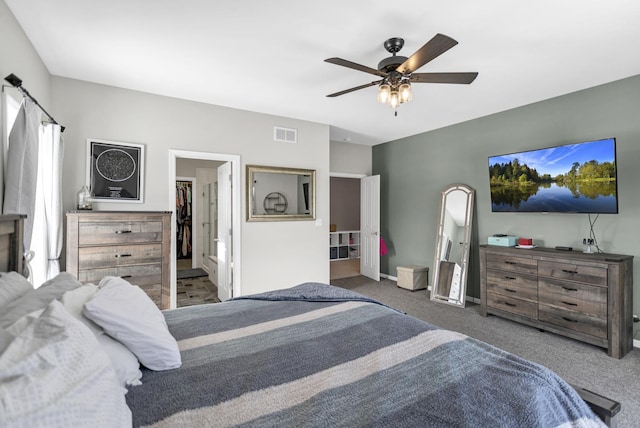 bedroom featuring baseboards, visible vents, dark carpet, and a ceiling fan