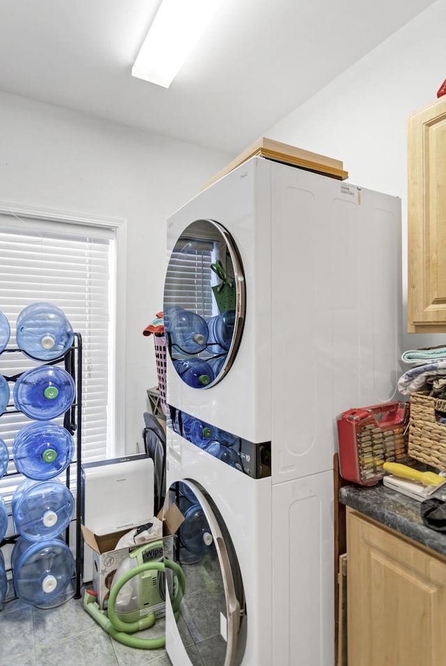 clothes washing area featuring stacked washer / drying machine