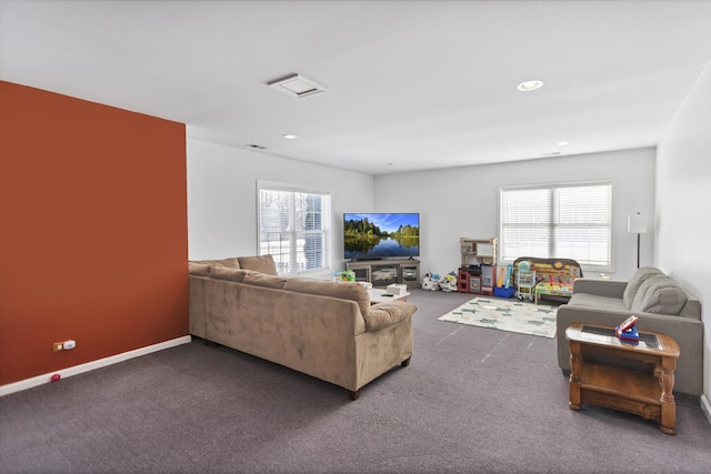 living room with dark colored carpet, a healthy amount of sunlight, visible vents, and recessed lighting