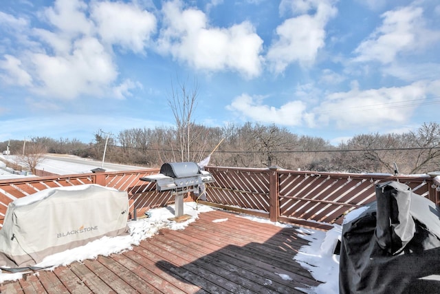 snow covered deck featuring a grill