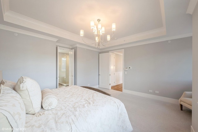 carpeted bedroom with a tray ceiling, crown molding, and an inviting chandelier