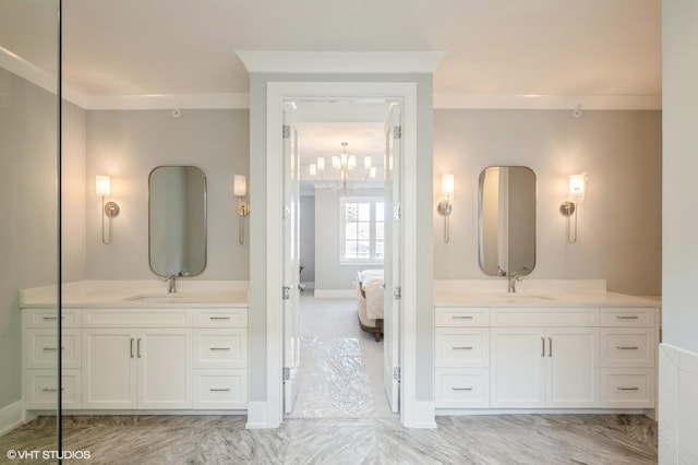 bathroom with vanity, ornamental molding, and a chandelier