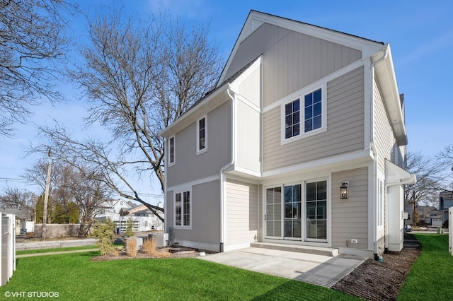 rear view of house with a patio area and a yard