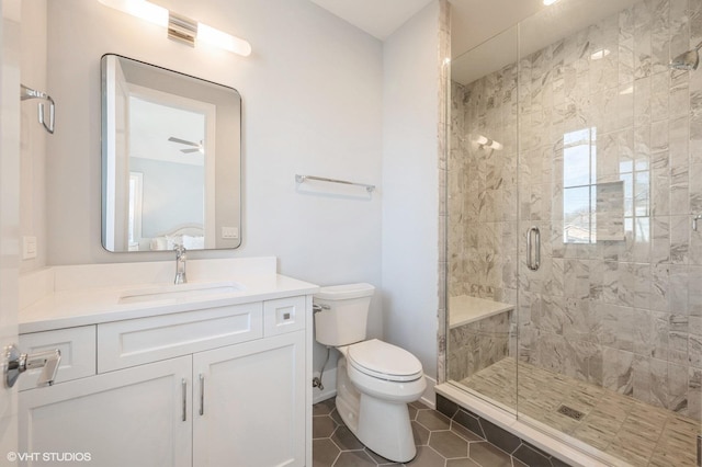 bathroom with toilet, tile patterned flooring, walk in shower, and vanity