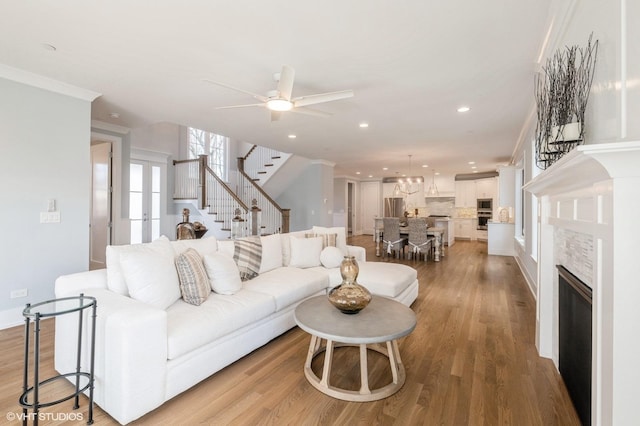 living room with light wood-type flooring and ceiling fan