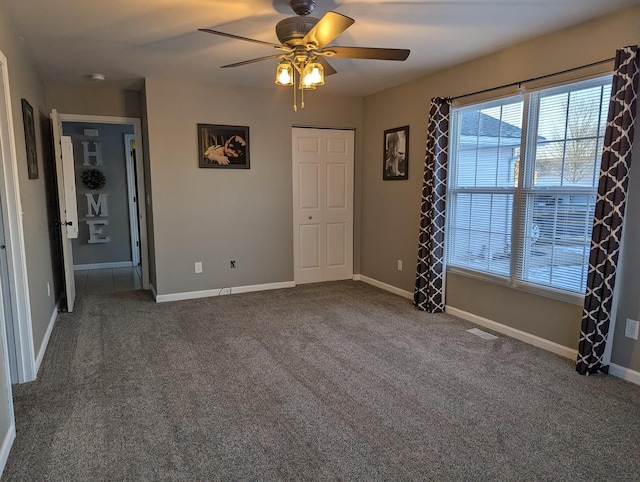 unfurnished bedroom with ceiling fan and carpet