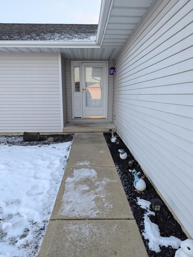 view of snow covered property entrance