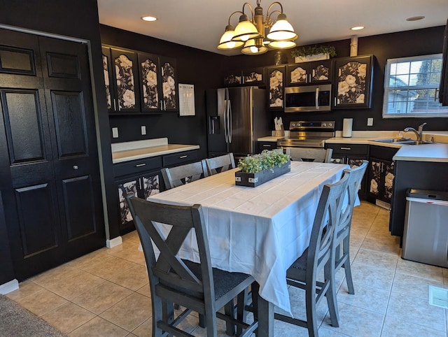 tiled dining room with sink and an inviting chandelier