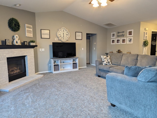 carpeted living room featuring ceiling fan, vaulted ceiling, and a brick fireplace