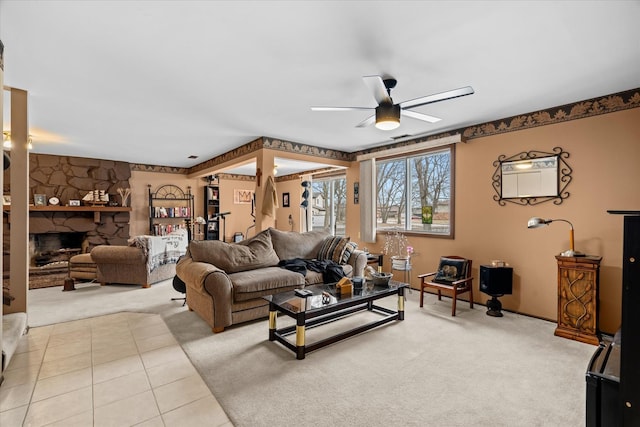 carpeted living room featuring ceiling fan and a fireplace