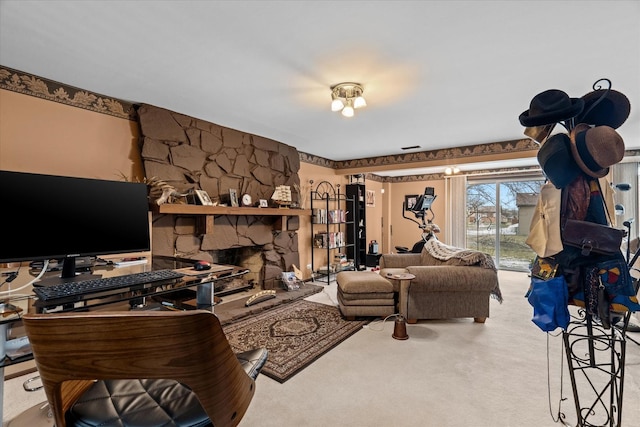 carpeted living room featuring a stone fireplace