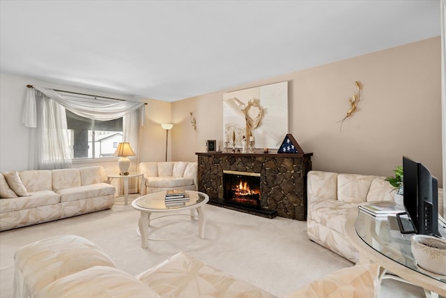 living room with a stone fireplace and carpet flooring